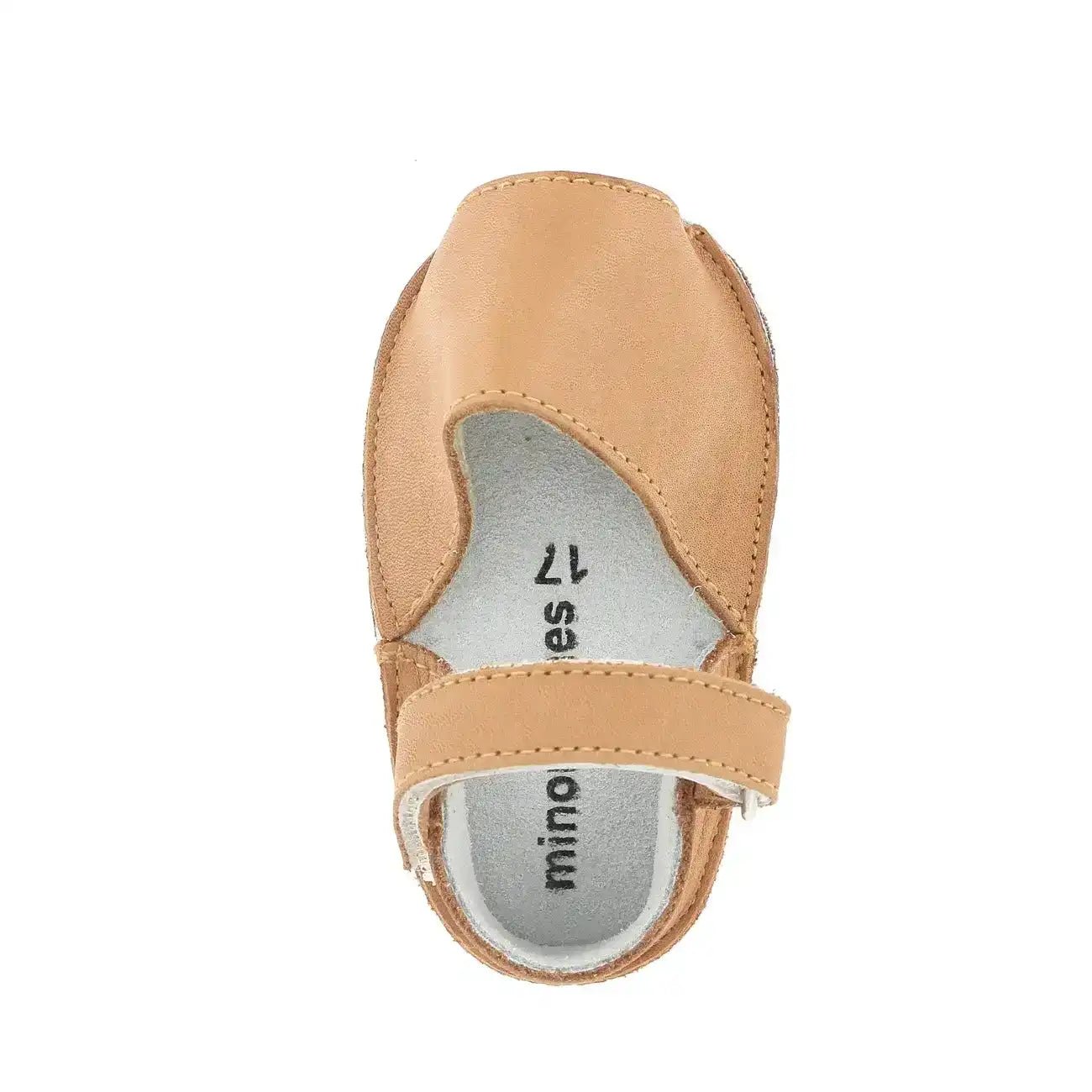 Natural leather baby shoe with hook-and-loop strap, top view on white background
