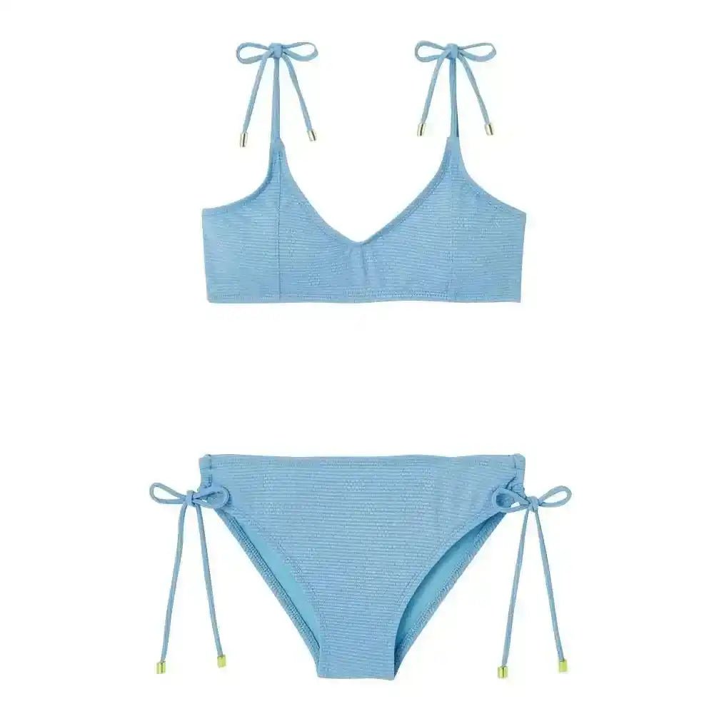 Sky blue textured girls two-piece swimsuit with tie straps on shoulders and sides.
