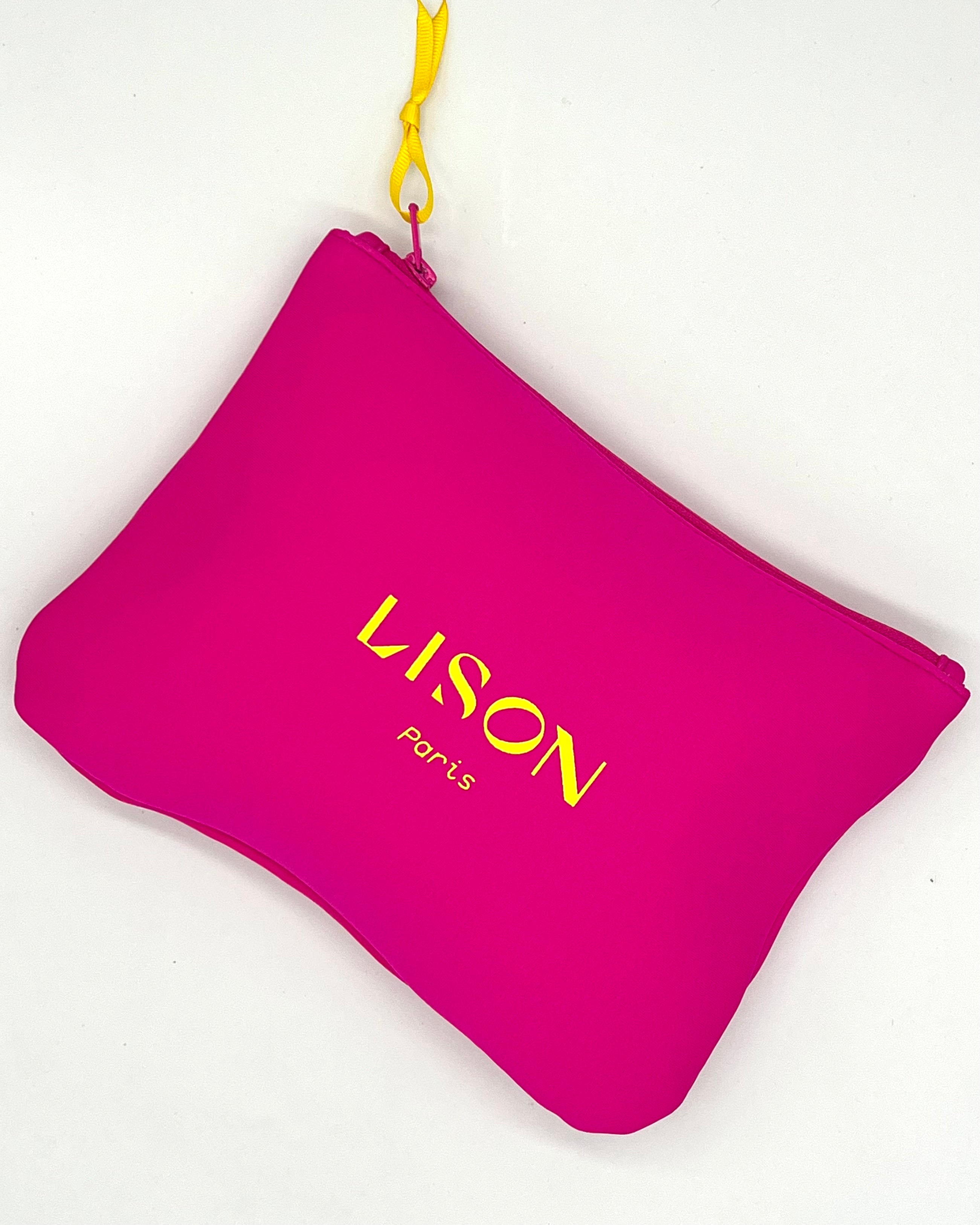 Pink Lison Paris pouch with yellow logo, yellow zipper pull, on white background