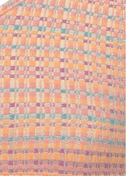 Close-up of textured fabric with orange, pink, and teal checkered pattern